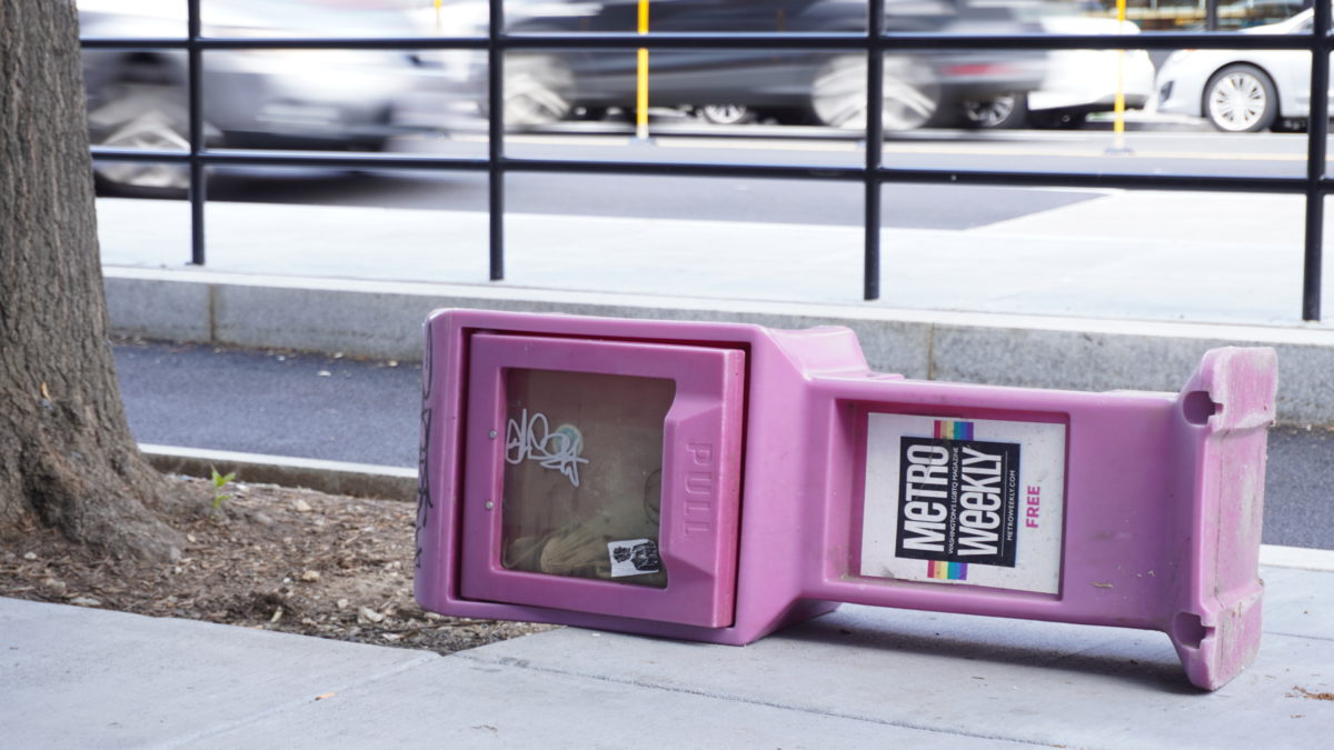 picture of a tipped over newspaper stand